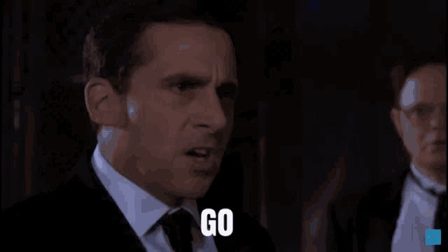 a man in a suit and tie with the words go puck yourself below him