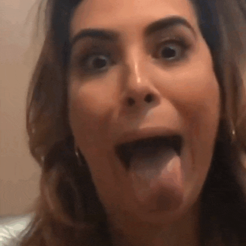 a close up of a woman 's face with her tongue out .