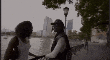 a man and a woman are standing next to each other on a sidewalk
