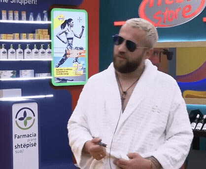 a man in a bathrobe is standing in front of a pharmacy