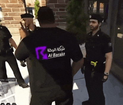 a man wearing a black shirt with al baraka on the back