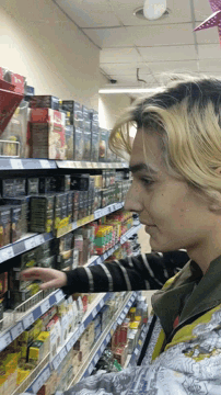 a person is looking at a shelf with a box that says ' strawberry ' on it