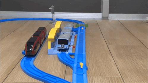 a toy train set on a wood floor