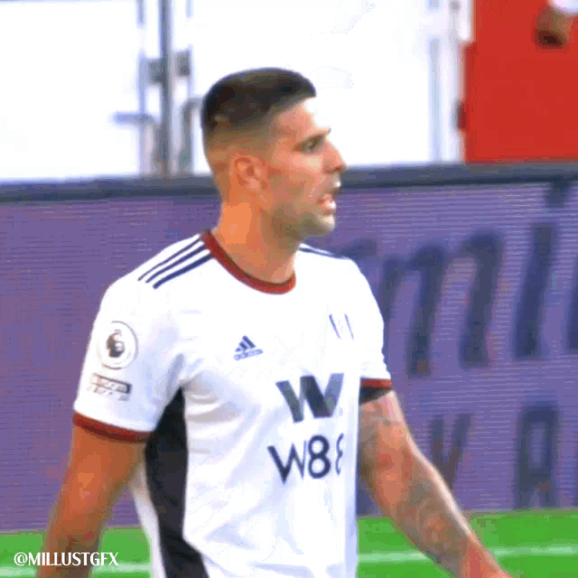 a soccer player wearing a white adidas jersey with w8 on it