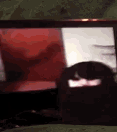 a person 's shadow is visible in front of a computer screen