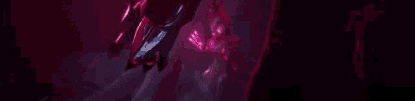 a close up of a sword in a dark room with a red background .