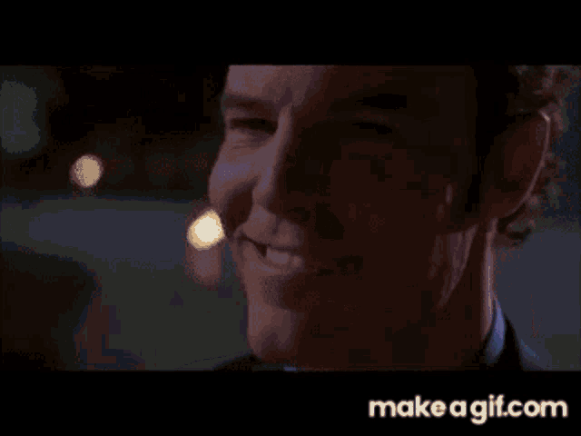 a close up of a man 's face with make a gif.com in the bottom right corner