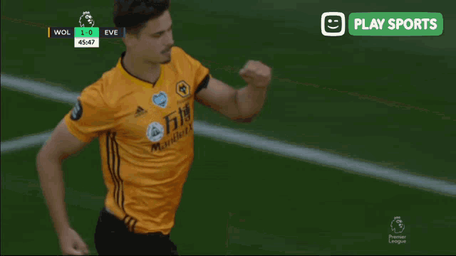 a soccer player in a yellow jersey runs on the field