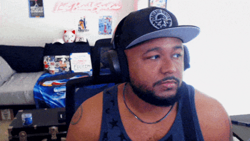a man wearing headphones and a hat with a skull and crossbones logo on it