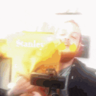 a blurred image of a man holding a stanley sign