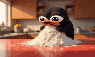 a penguin is eating a pile of flour on a red table
