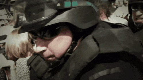 a man wearing a helmet and goggles looks at the camera