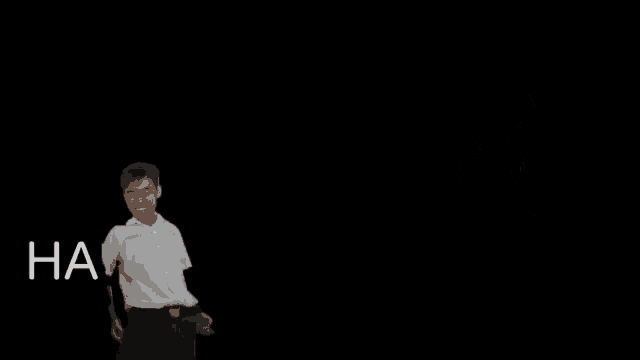 a man in a white shirt stands in front of a black background with the words ha ha ha