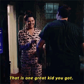 a man and woman are standing next to each other and the man says that is one great kid you got