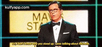 a man in a tuxedo and bow tie is talking to someone