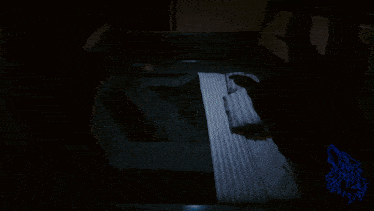 a shadow of a person 's hand is cast on a striped blanket