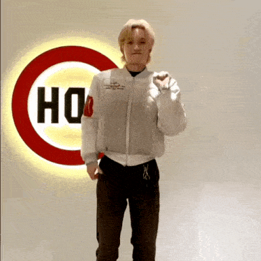 a person standing in front of a sign that says ho on it
