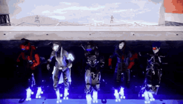a group of people are dancing in a dark room with purple lights