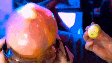 a person is holding a yellow ball with the letters s.a.f.f.f.f. on it