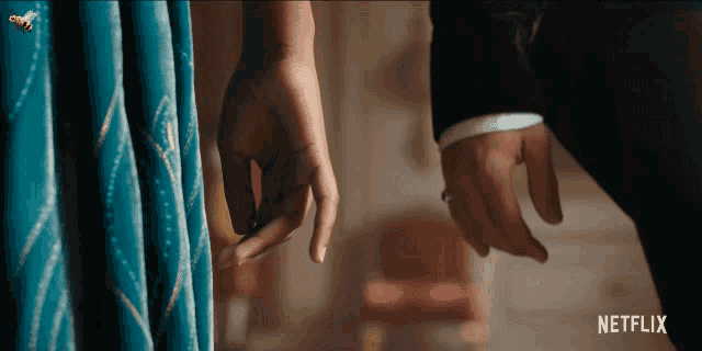 a man and a woman holding hands with netflix written on the bottom