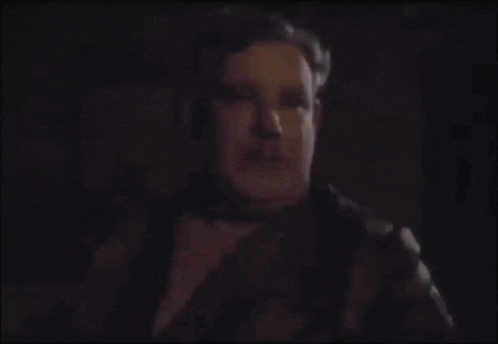 a blurry picture of a man 's face in the dark .
