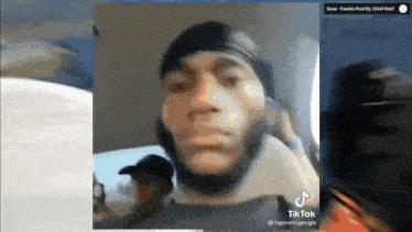 a man with a beard is talking on a cell phone .