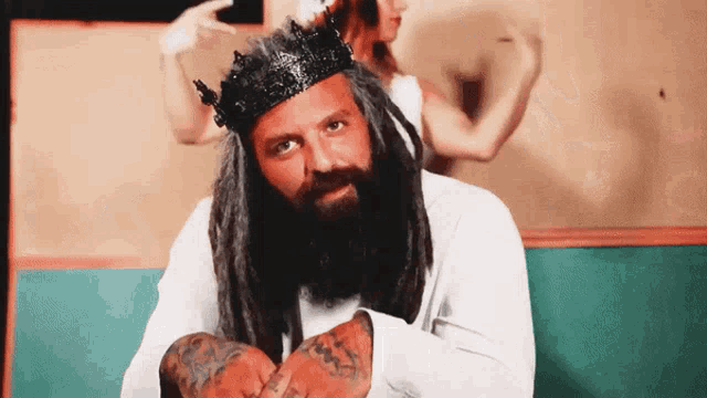 a man with dreadlocks wearing a crown on his head
