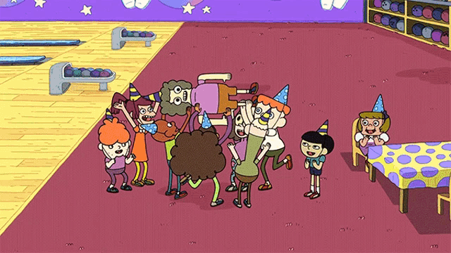 a group of cartoon characters wearing party hats are standing around a table in a bowling alley