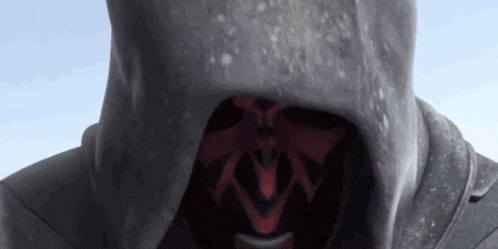 a close up of a person wearing a hooded sweatshirt with a mask on their face .