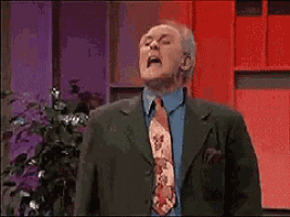 a man in a suit and tie with his mouth open says it 's on .
