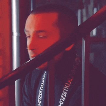 a man wearing a black shirt with a lanyard around his neck that says dzdzdzdzdzdzdzdzdz