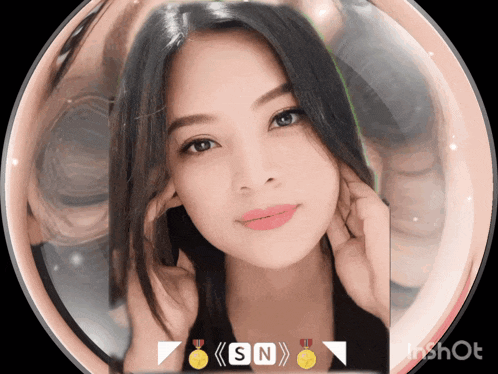 a woman 's face is surrounded by a sphere with the letters sn on the bottom