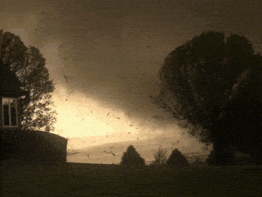 a house is silhouetted against a cloudy sky with trees in the foreground