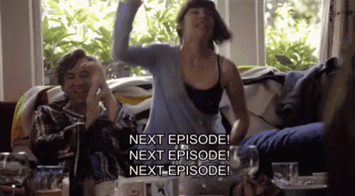 a woman is dancing in a living room while a man sits on a couch and says next episode next episode next episode