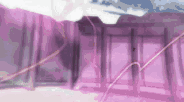 a blurred image of a building with a purple wall and stairs
