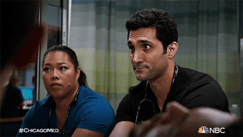 a man and a woman are sitting next to each other and the hashtag #chicagomed