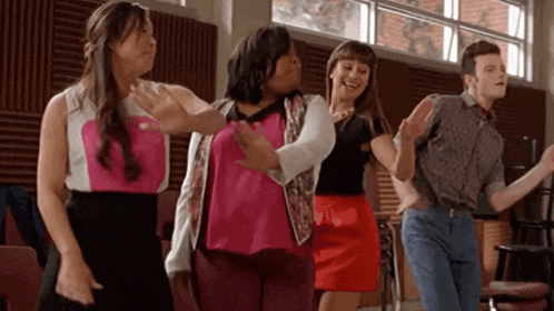 a group of people are dancing in a room together .