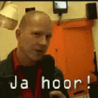 a man in a red shirt and black jacket says ja hoor !
