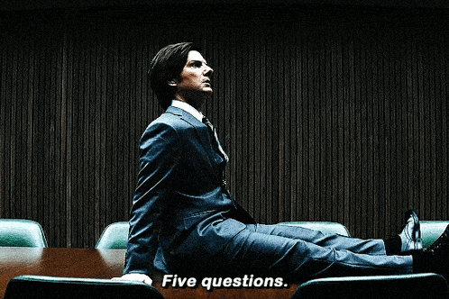 a close up of a man 's face with the words five questions visible