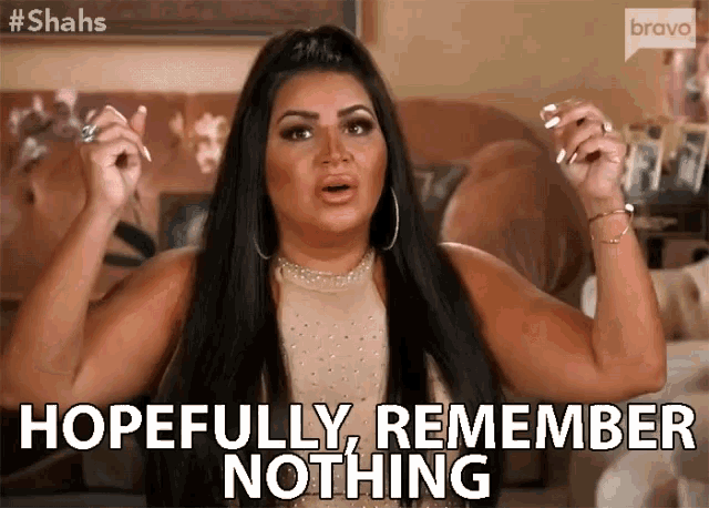 a woman is sitting in a living room with her hands in the air and says hopefully remember nothing .