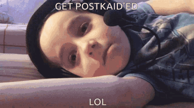 a young boy wearing headphones and a microphone with the words get postkaid 'ed lol on the bottom