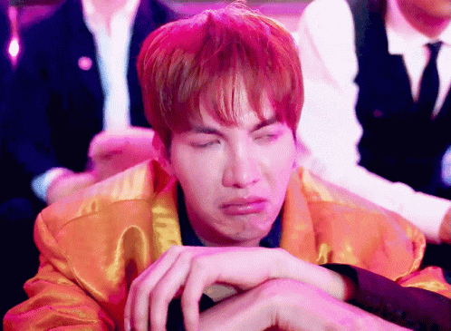 a young man with red hair is making a funny face