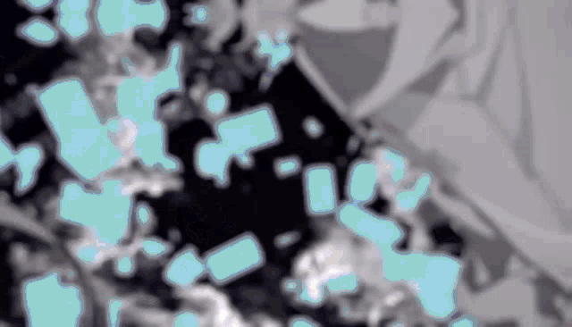 a blurred image of a person 's face with a few blue squares in the background