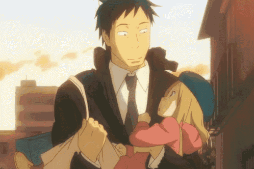a man in a suit and tie carrying a little girl