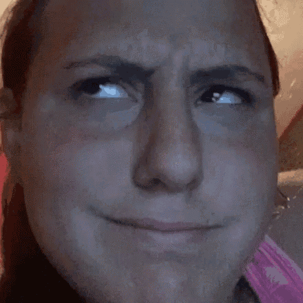 a close up of a woman 's face making a funny face .