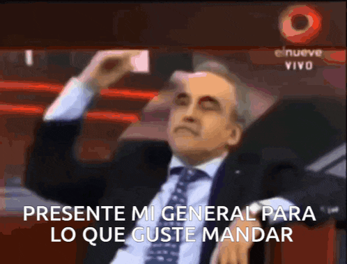 a man in a suit and tie says presente mi general para lo que guste mandar