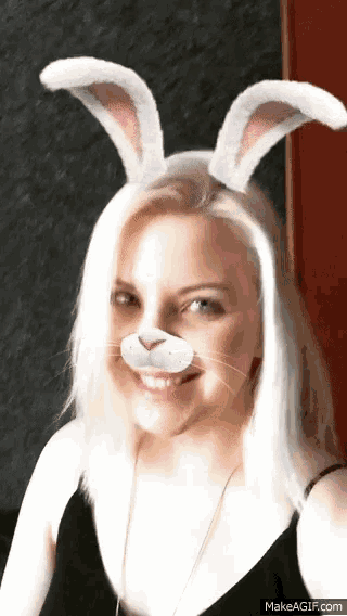 a woman wearing bunny ears and a fake nose is smiling