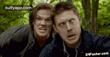 two men are making funny faces while standing next to each other .