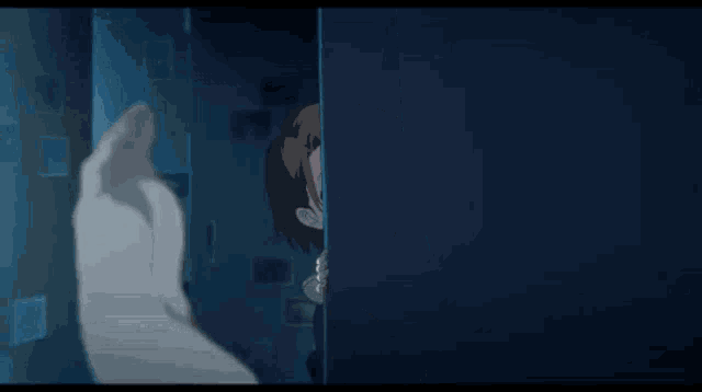 a girl is standing in a dark room with a hand reaching out towards her