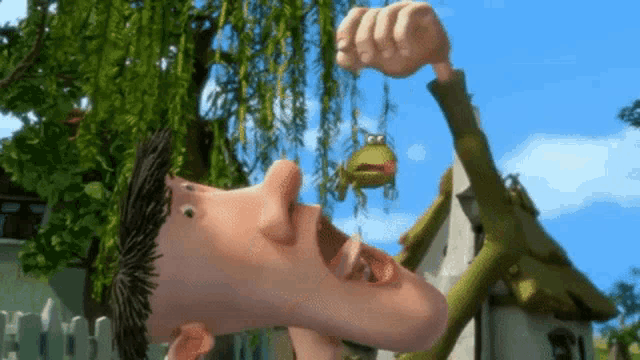 a man is holding a frog in his mouth
